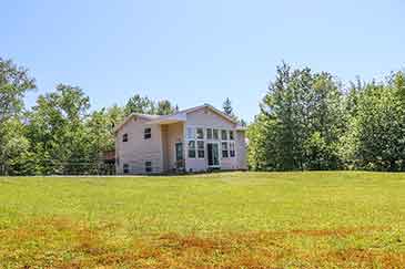 Bras d’Or Beach House for sale in Little Narrows, Cape Breton, Nova Scotia, with extra apartment and garage